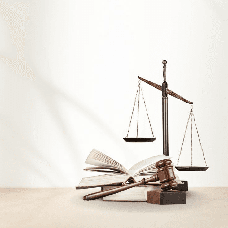 Scales of justice, a wooden gavel, and open law books on a clean professional background